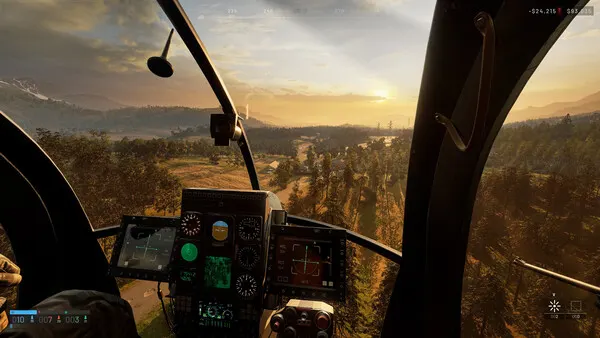 View from a helicopter cockpit over forest and fields at sunset