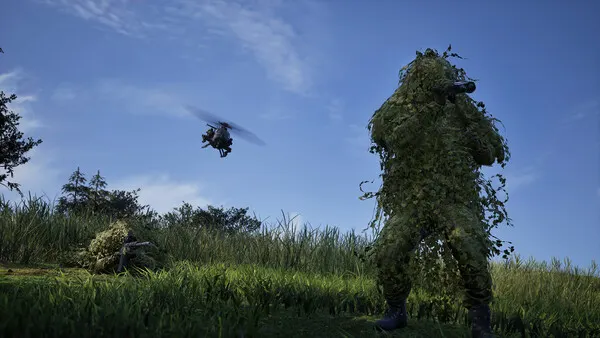 Recon in a ghillie suit, an attack helicopter over the field behind